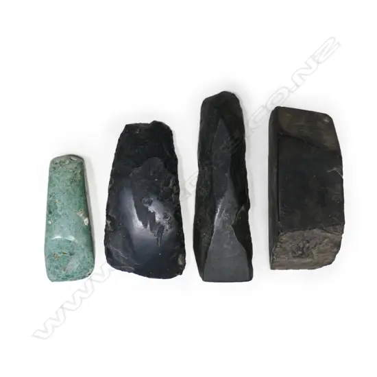 Two old Māori small stone toki, one modern green stone adze and a small sharpening block,